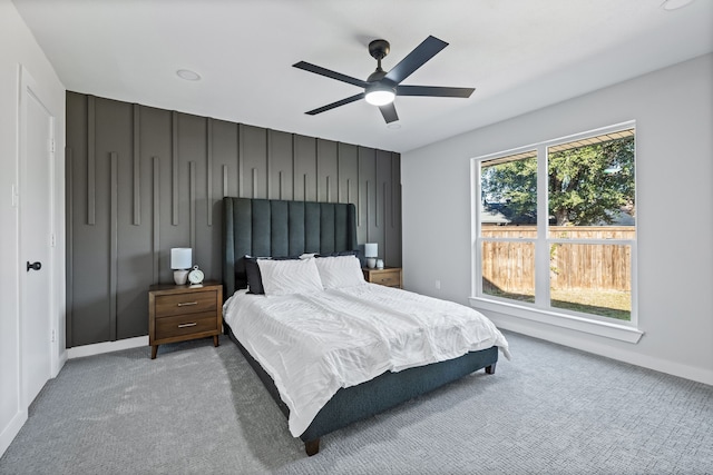 carpeted bedroom with baseboards and a ceiling fan