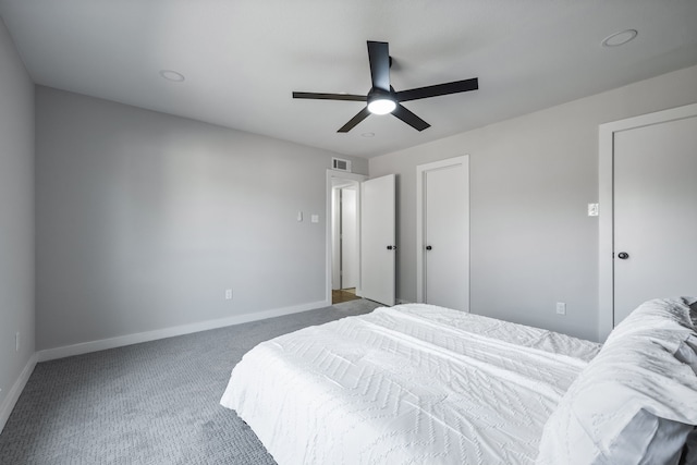 carpeted bedroom with visible vents, baseboards, and ceiling fan