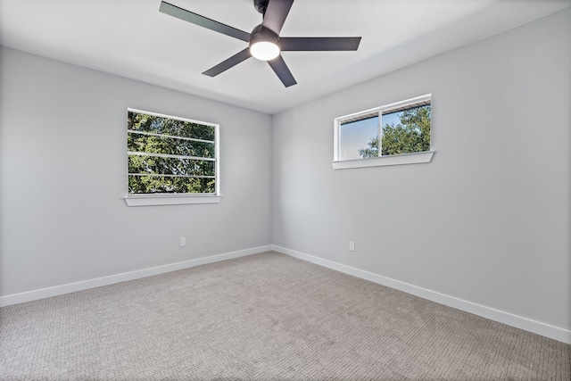 spare room with baseboards and ceiling fan