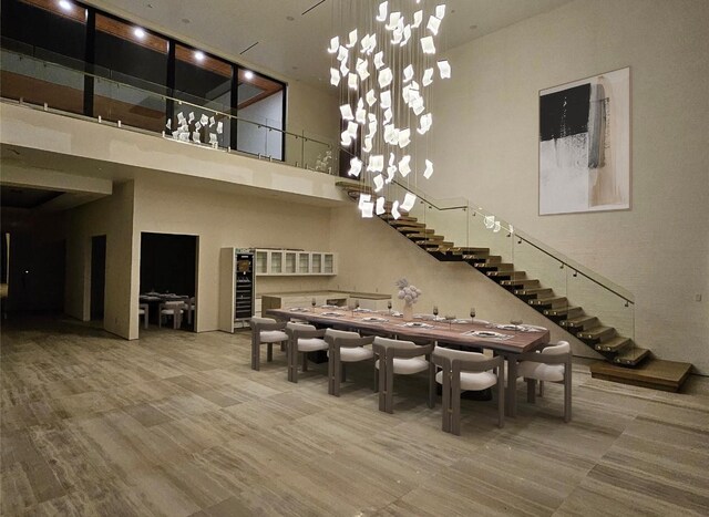 4625 Walnut Hill Ln, Dallas, TX 75229 - dining space featuring wine cooler, stairway, and a high ceiling