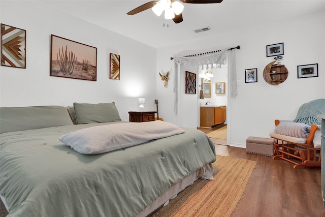 7634 Preston Rd, Denison, TX 75020 - bedroom featuring wood finished floors, connected bathroom, and a ceiling fan