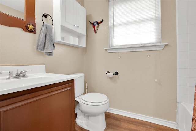 7634 Preston Rd, Denison, TX 75020 - bathroom featuring vanity, toilet, wood finished floors, a tub, and a shower