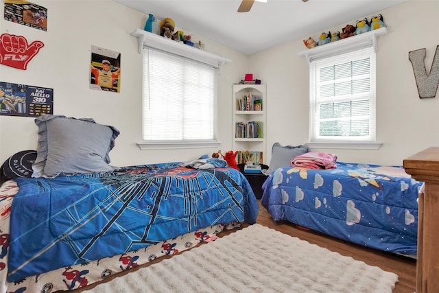 7634 Preston Rd, Denison, TX 75020 - bedroom with multiple windows, wood finished floors, and a ceiling fan