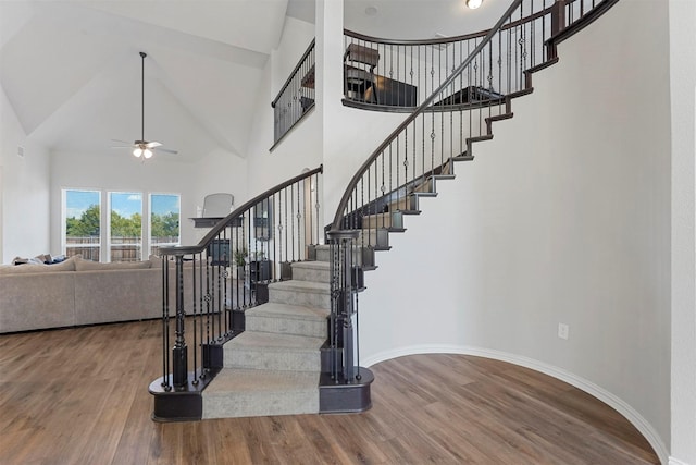 2506 Chalmers Rd, Glenn Heights, TX 75154 - stairway featuring wood finished floors, high vaulted ceiling, a ceiling fan, and baseboards