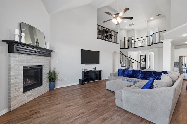 2506 Chalmers Rd, Glenn Heights, TX 75154 - living area with a ceiling fan, stairs, wood finished floors, high vaulted ceiling, and a brick fireplace