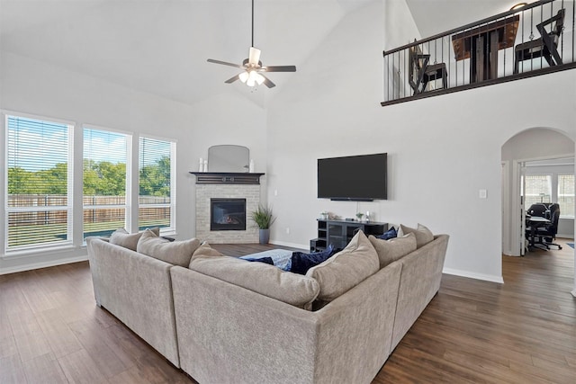 2506 Chalmers Rd, Glenn Heights, TX 75154 - living area featuring arched walkways, ceiling fan, dark wood-type flooring, baseboards, and a brick fireplace