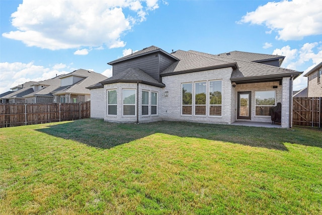 2506 Chalmers Rd, Glenn Heights, TX 75154 - back of house with roof with shingles, a patio, and brick siding