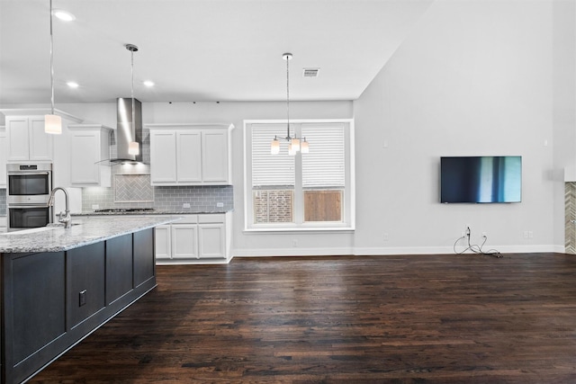 2507 Lavaca Dr, Euless, TX 76039 - kitchen with wall chimney exhaust hood, white cabinets, gas stovetop, tasteful backsplash, and dark wood-type flooring