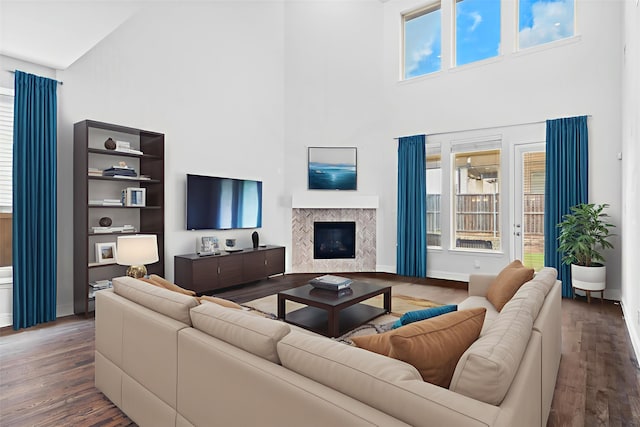 2507 Lavaca Dr, Euless, TX 76039 - living room featuring a towering ceiling, wood finished floors, a fireplace, and baseboards