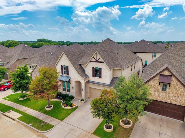 2507 Lavaca Dr, Euless, TX 76039 - french country style house featuring an attached garage, concrete driveway, a shingled roof, brick siding, and stucco siding