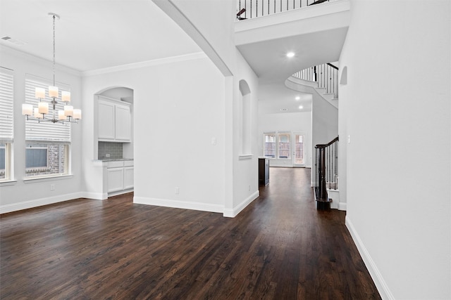 2507 Lavaca Dr, Euless, TX 76039 - unfurnished living room with stairs, a chandelier, dark wood-style flooring, baseboards, and ornamental molding