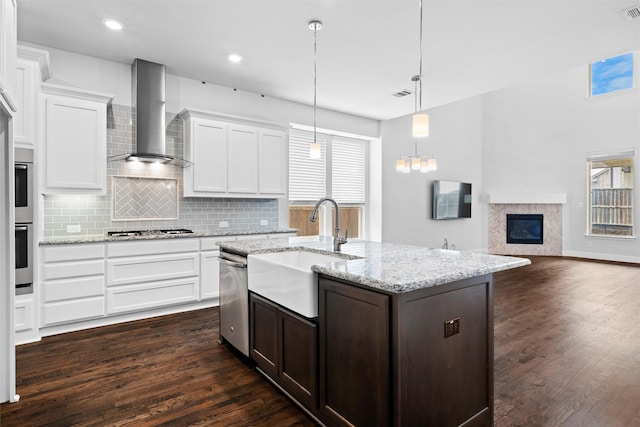 2507 Lavaca Dr, Euless, TX 76039 - kitchen with wall chimney exhaust hood, a sink, appliances with stainless steel finishes, decorative backsplash, and dark wood-style floors