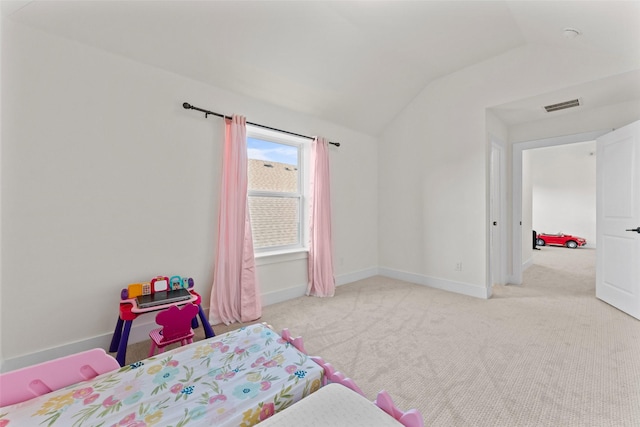 carpeted bedroom with visible vents, baseboards, and lofted ceiling