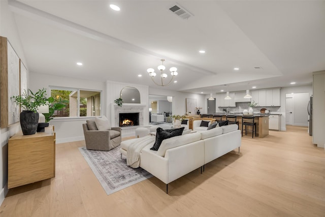 4508 Thunder Rd, Dallas, TX 75244 - living room with lofted ceiling, light wood-type flooring, a chandelier, a warm lit fireplace, and recessed lighting