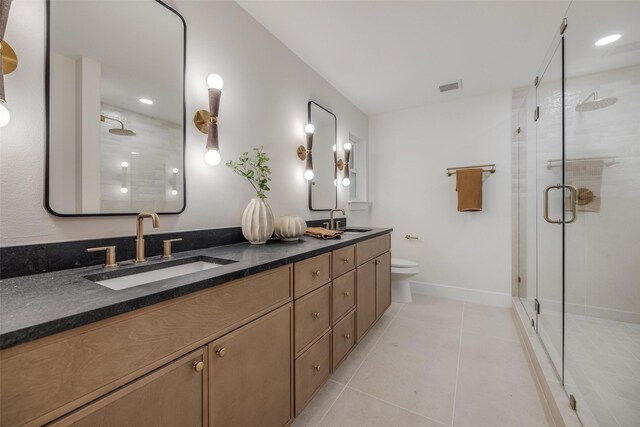 4508 Thunder Rd, Dallas, TX 75244 - full bathroom featuring a shower stall, tile patterned floors, double vanity, toilet, and baseboards