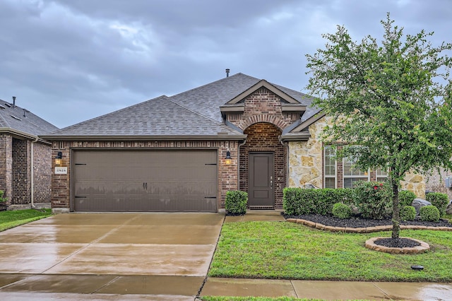 2828 Ainsworth Rd, Aubrey, TX 76227 - french provincial home with roof with shingles, brick siding, an attached garage, concrete driveway, and a front yard