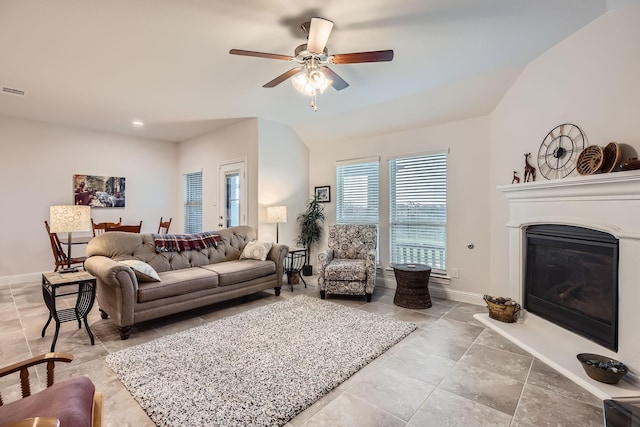 2828 Ainsworth Rd, Aubrey, TX 76227 - living area featuring ceiling fan, a glass covered fireplace, baseboards, tile patterned floors, and lofted ceiling