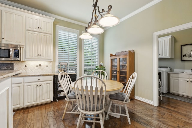 308 Dunlin Ln, Coppell, TX 75019 - dining area featuring ornamental molding, dark wood-style flooring, baseboards, and washer / clothes dryer