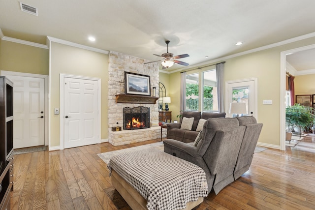 308 Dunlin Ln, Coppell, TX 75019 - living area with visible vents, a fireplace, light wood finished floors, crown molding, and ceiling fan