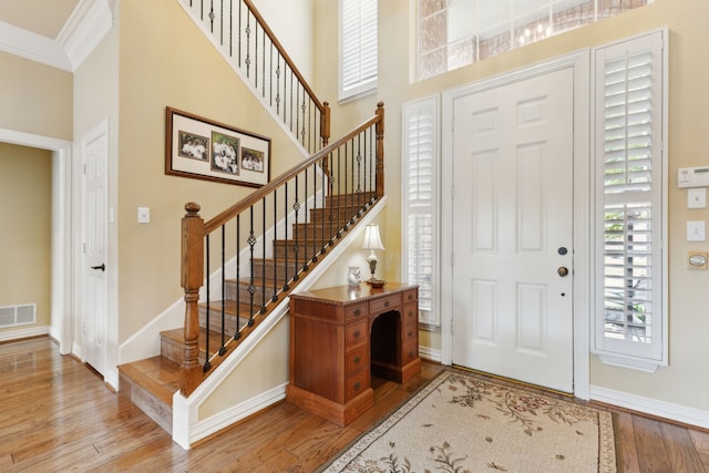 308 Dunlin Ln, Coppell, TX 75019 - foyer entrance with stairs, wood finished floors, ornamental molding, visible vents, and baseboards