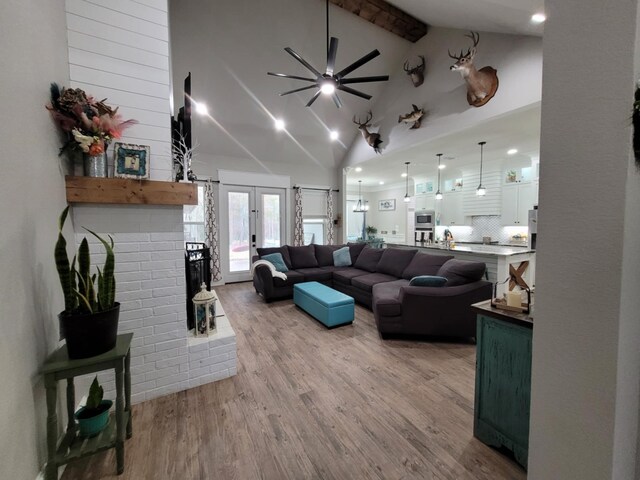 12890 County Road 463, Tyler, TX 75706 - living room featuring wood finished floors, ceiling fan, beam ceiling, french doors, and recessed lighting
