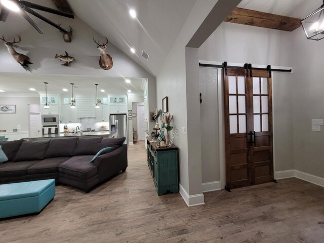 12890 County Road 463, Tyler, TX 75706 - living area featuring a barn door, light wood-type flooring, recessed lighting, and baseboards