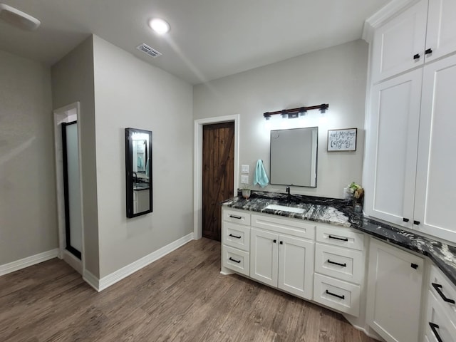 12890 County Road 463, Tyler, TX 75706 - bathroom with wood finished floors, baseboards, vanity, and recessed lighting
