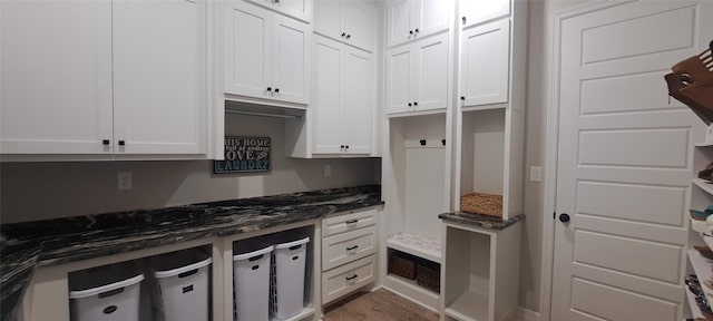 12890 County Road 463, Tyler, TX 75706 - kitchen with white cabinetry, dark stone countertops, and wood finished floors