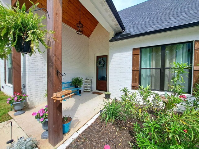 12890 County Road 463, Tyler, TX 75706 - property entrance featuring roof with shingles and brick siding