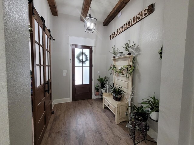 12890 County Road 463, Tyler, TX 75706 - entryway featuring beam ceiling, a barn door, and wood finished floors