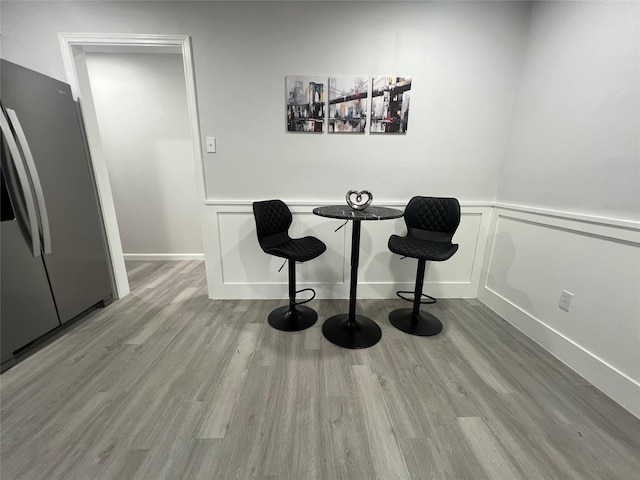 2721 San Marcus Ave, Dallas, TX 75228 - dining room featuring wood finished floors, a wainscoted wall, and a decorative wall
