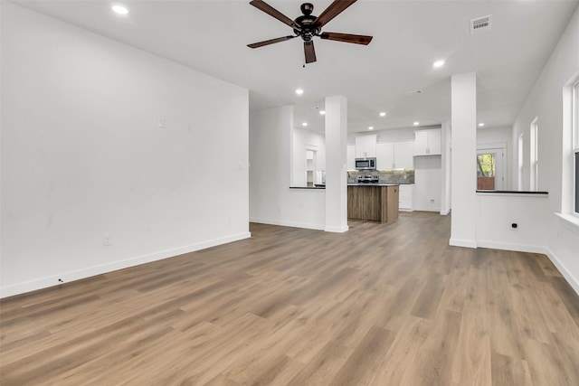 unfurnished living room with ceiling fan, light wood-style floors, recessed lighting, and visible vents