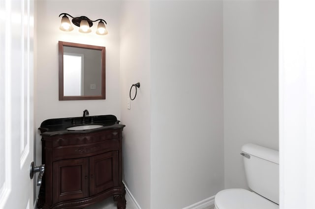 bathroom featuring toilet and vanity