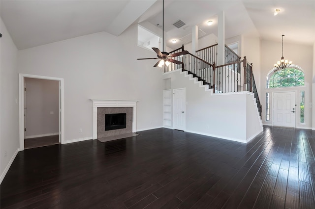 unfurnished living room featuring stairs, visible vents, a fireplace, and high vaulted ceiling