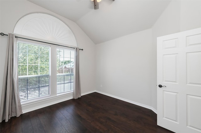 spare room with baseboards, dark wood-style flooring, ceiling fan, and vaulted ceiling