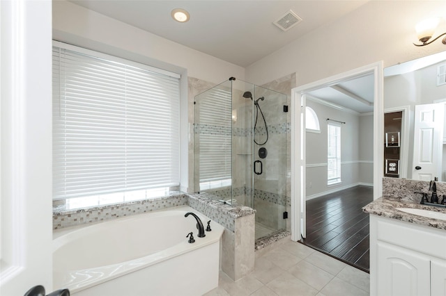 full bathroom with a stall shower, visible vents, tile patterned flooring, a garden tub, and vanity