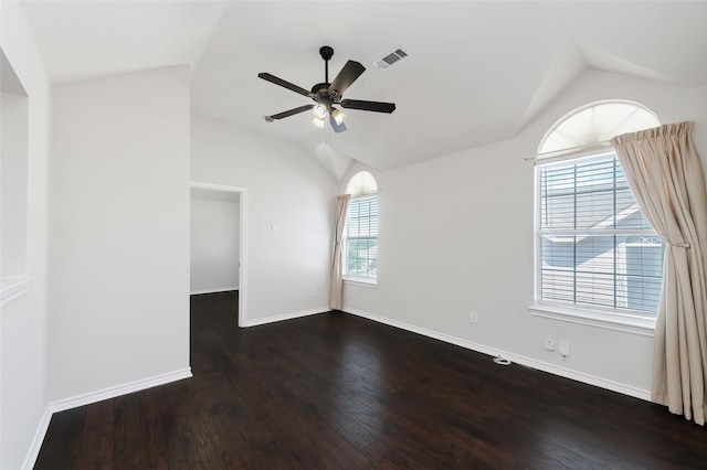 unfurnished room with lofted ceiling, visible vents, a ceiling fan, and dark wood-type flooring