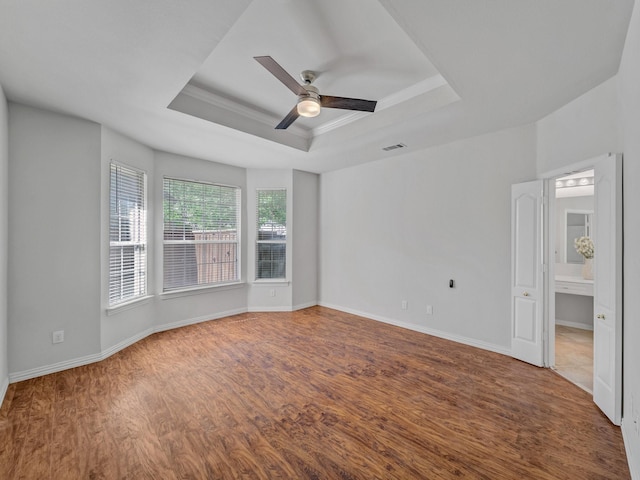 2035 Greenfield Ln, Allen, TX 75013 - spare room with a tray ceiling, baseboards, ceiling fan, visible vents, and wood finished floors