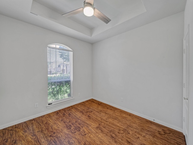 2035 Greenfield Ln, Allen, TX 75013 - empty room with a tray ceiling, baseboards, a ceiling fan, and wood finished floors