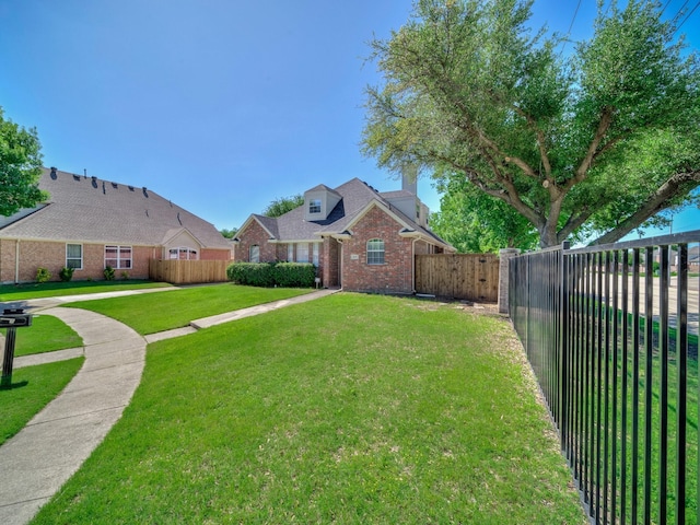 2035 Greenfield Ln, Allen, TX 75013 - view of front facade with a fenced backyard, a front lawn, and brick siding