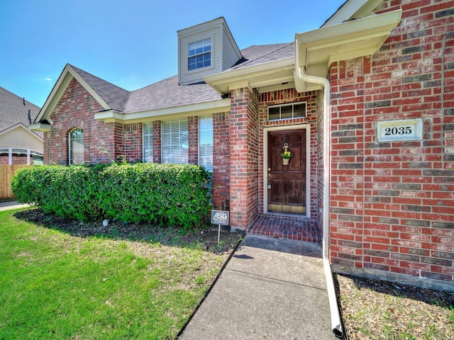 2035 Greenfield Ln, Allen, TX 75013 - property entrance featuring a lawn, roof with shingles, and brick siding