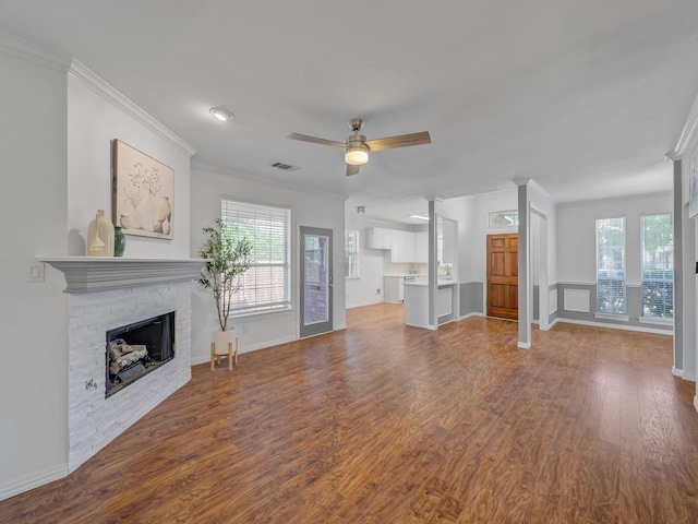 2035 Greenfield Ln, Allen, TX 75013 - unfurnished living room featuring baseboards, ceiling fan, crown molding, wood finished floors, and a fireplace