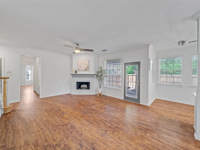 2035 Greenfield Ln, Allen, TX 75013 - unfurnished living room featuring a ceiling fan, baseboards, a fireplace, and wood finished floors