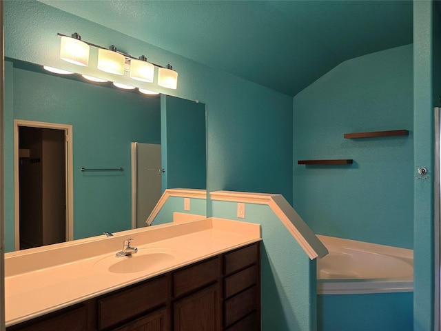 full bathroom with vanity, lofted ceiling, and a bath