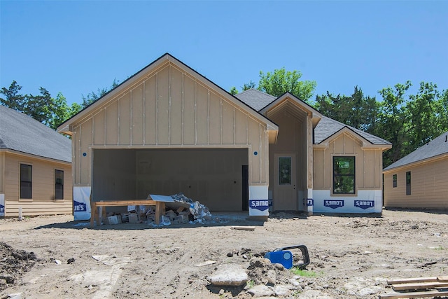 205 W Elm St, Whitewright, TX 75491 - property in mid-construction featuring a shingled roof, board and batten siding, and a garage