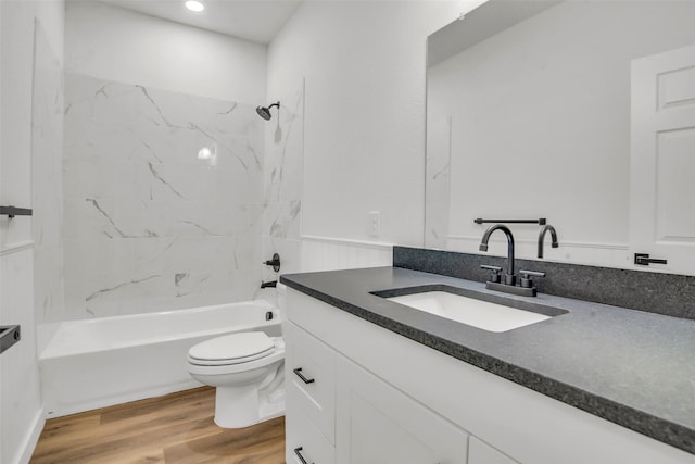 bathroom featuring toilet, wood finished floors, vanity, recessed lighting, and shower / bath combination