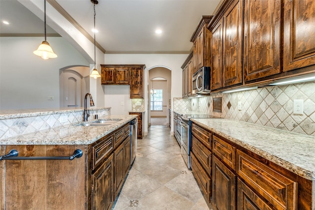 503 Olive Trl, Forney, TX 75126 - kitchen featuring stainless steel appliances, arched walkways, a sink, tasteful backsplash, and light stone counters