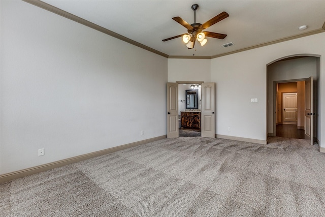 503 Olive Trl, Forney, TX 75126 - unfurnished bedroom with arched walkways, carpet flooring, baseboards, crown molding, and ensuite bathroom