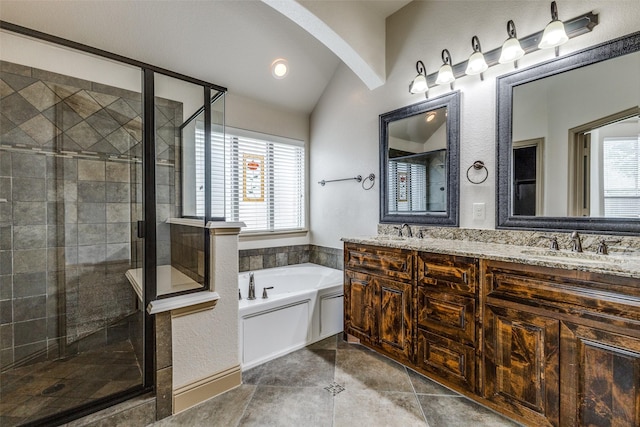 503 Olive Trl, Forney, TX 75126 - full bathroom with a garden tub, double vanity, a stall shower, vaulted ceiling, and tile patterned floors