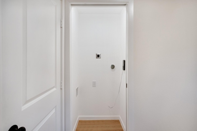 hallway with light wood finished floors and baseboards